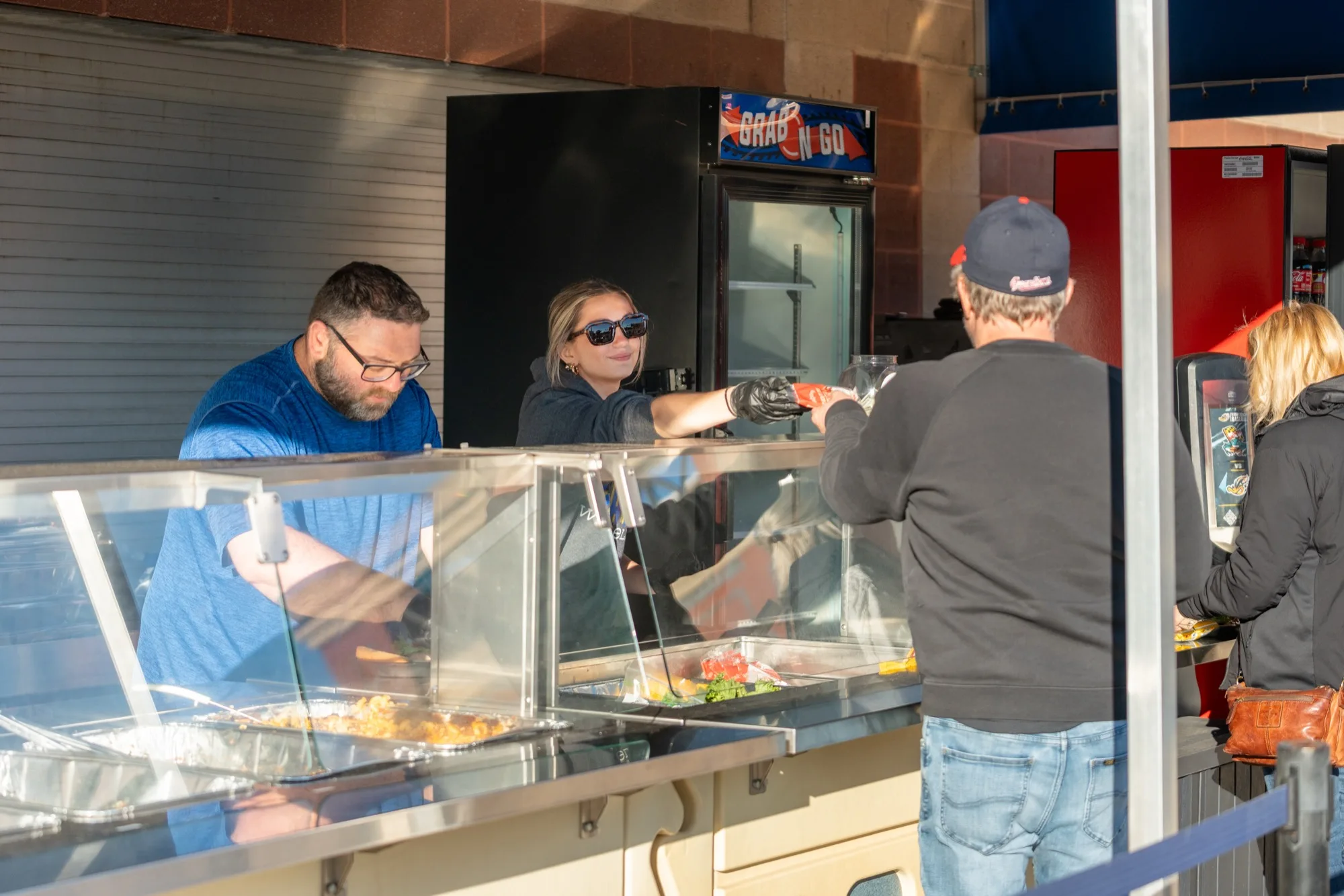 Akron RubberDucks staff serving guests at a ballpark food station