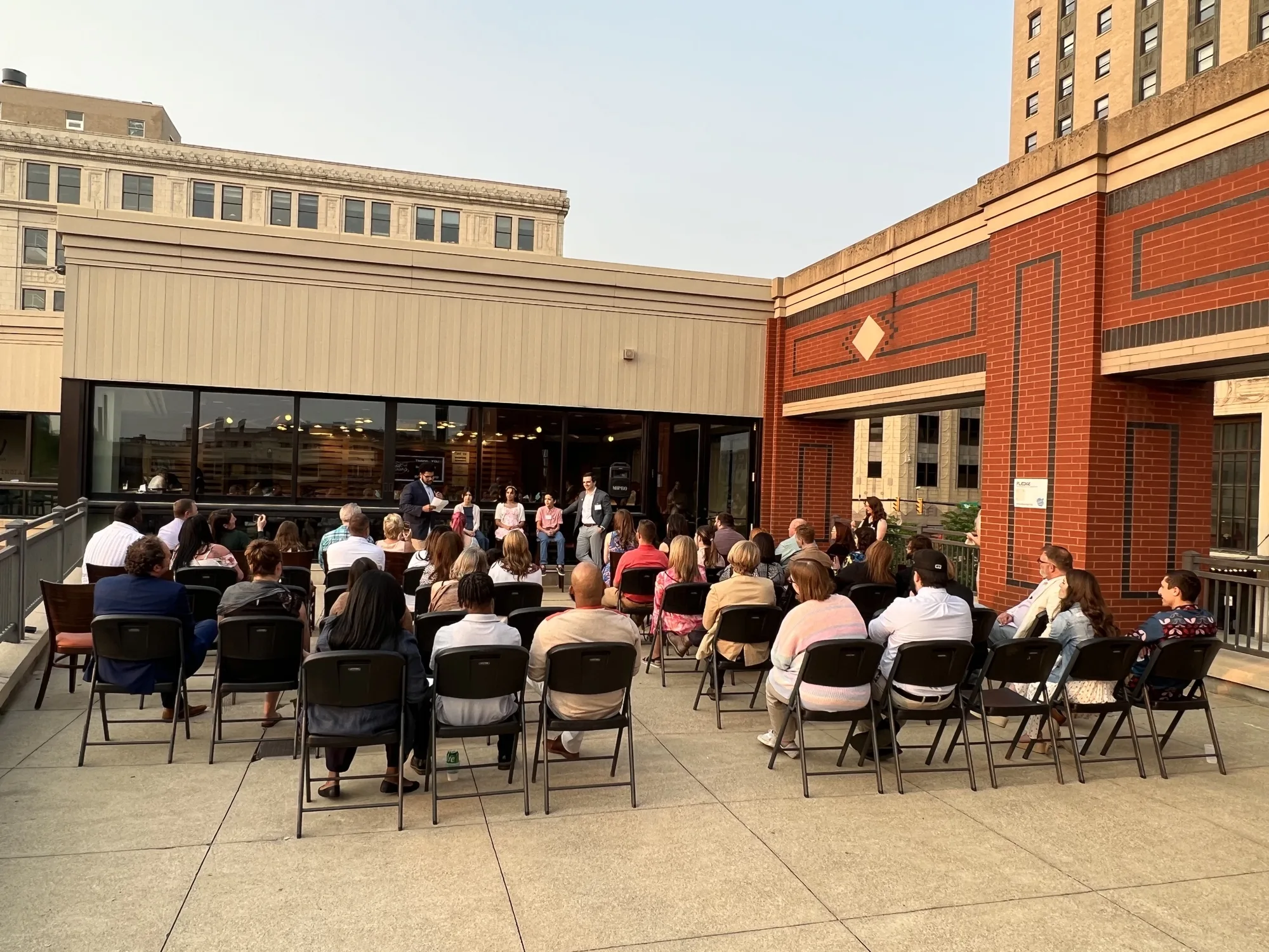 Guests attending a presentation on the Duck Club patio