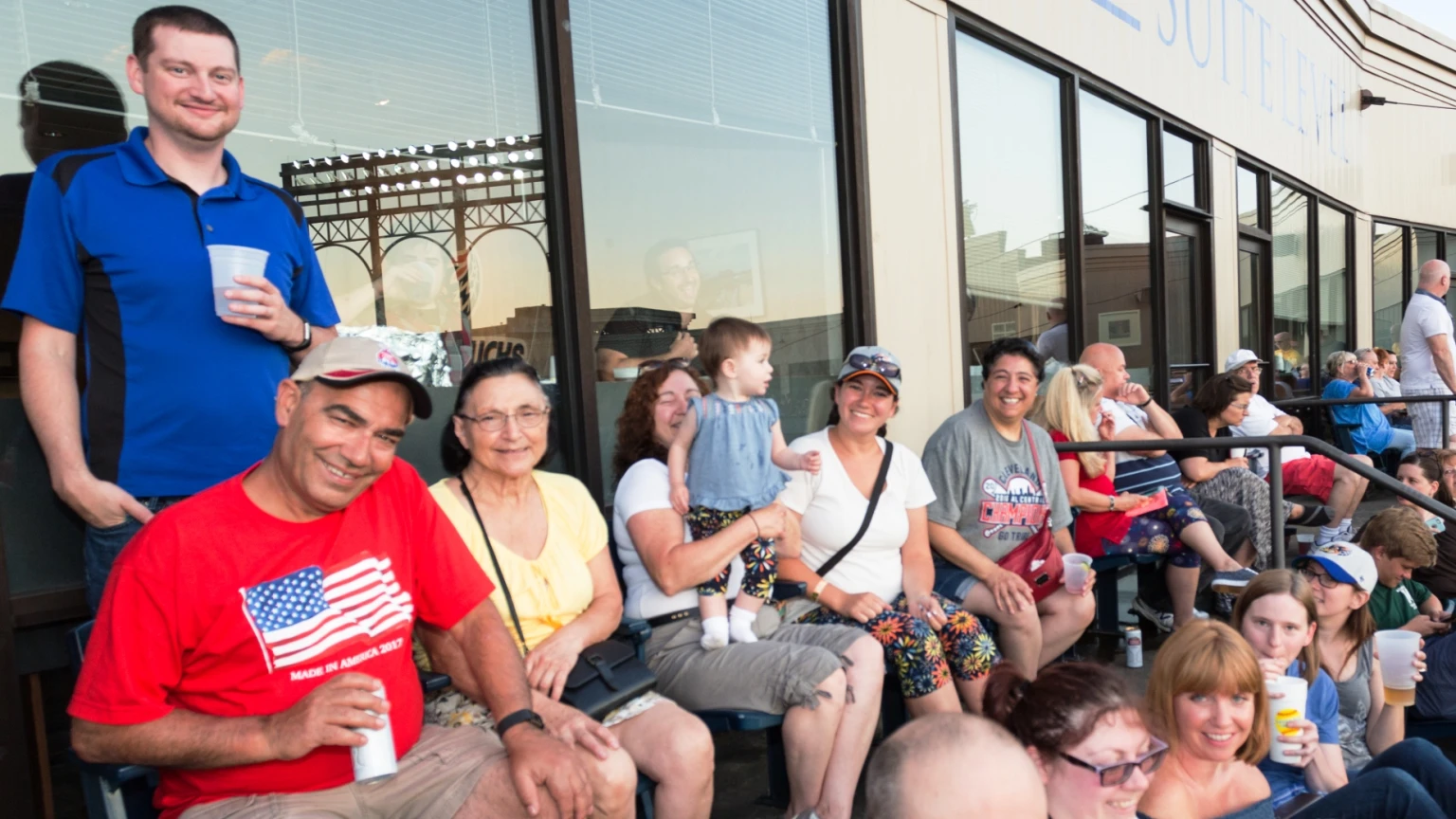 Guests seated outdoors along the J.W. Didado Electric Suite Level