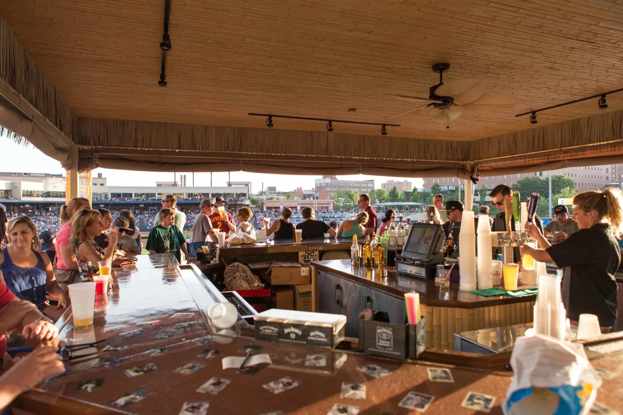 Guests gathering at the Modelo Tiki Terrace bar overlooking the ballpark
